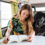 woman reading with dog