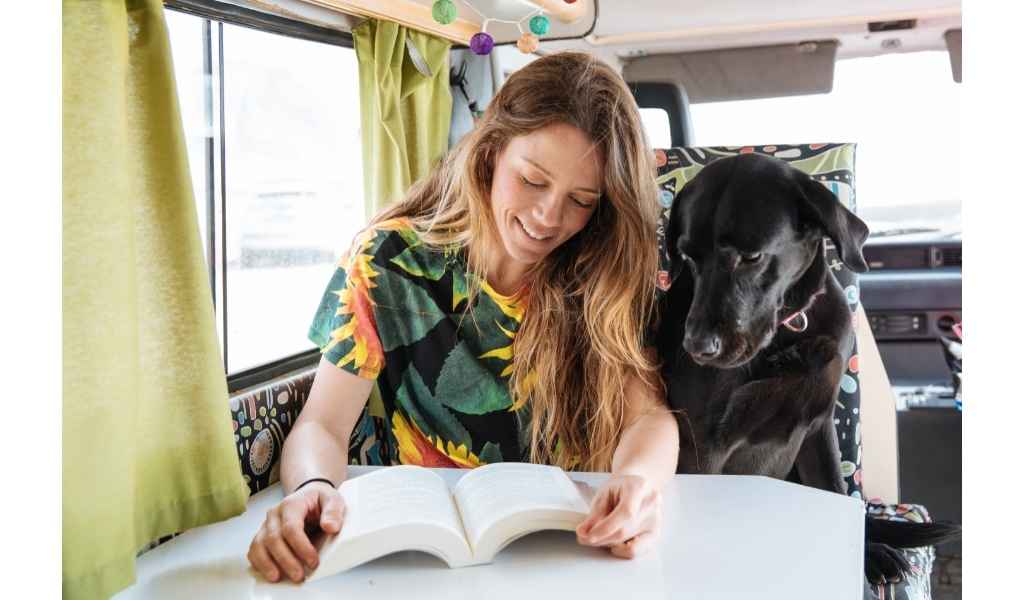 woman reading with her dog