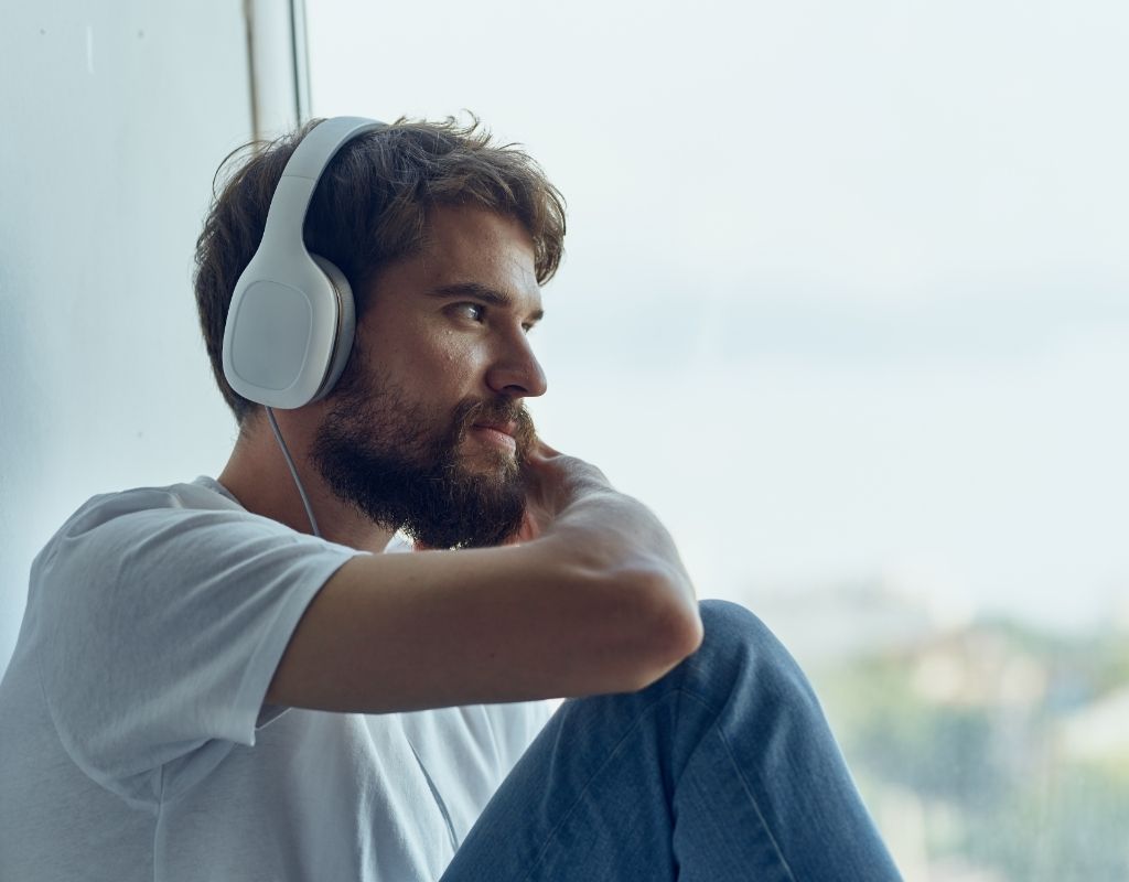 man with headphones listening to an audiobook