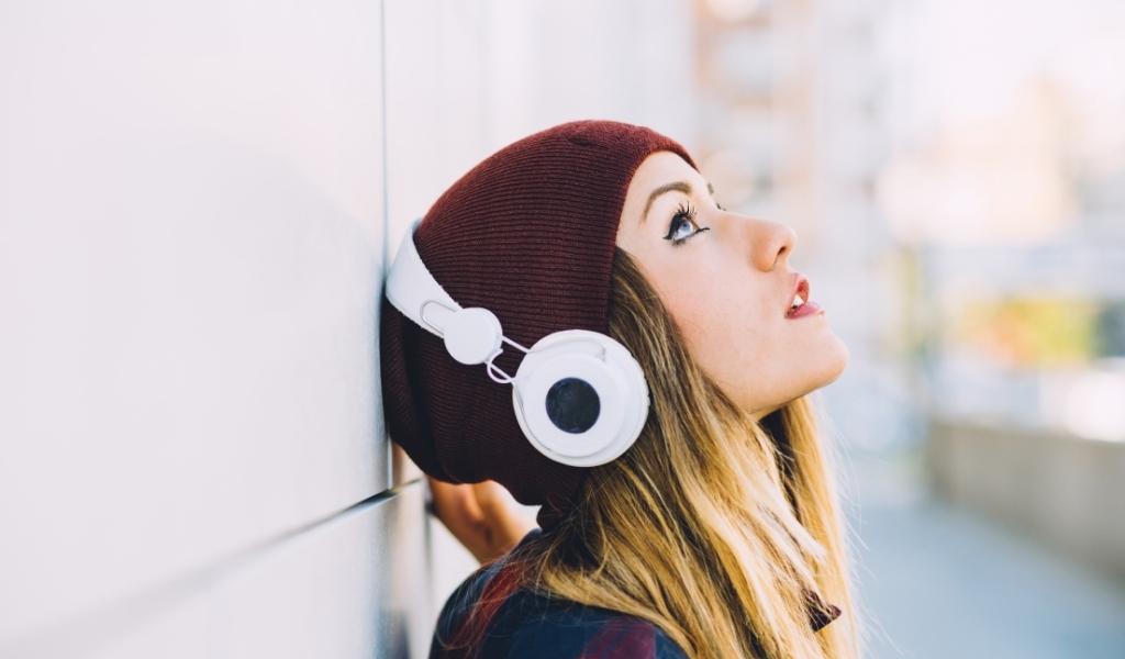 woman wearing headphones- best headphones 2021