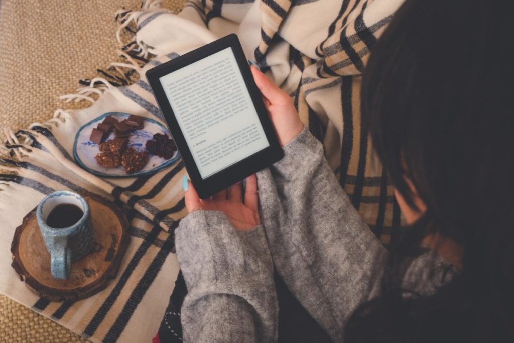 Is Kindle Unlimited worth it? Woman reading her e-book.